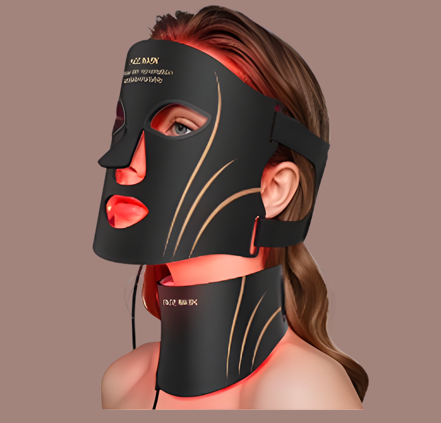 A woman wearing a black LED light therapy face and neck mask, shown in profile against a solid taupe background. The mask features gold-colored contour lines and text reading 'K-12 MAX LED' and 'OPTIMIZED DENSITY'.